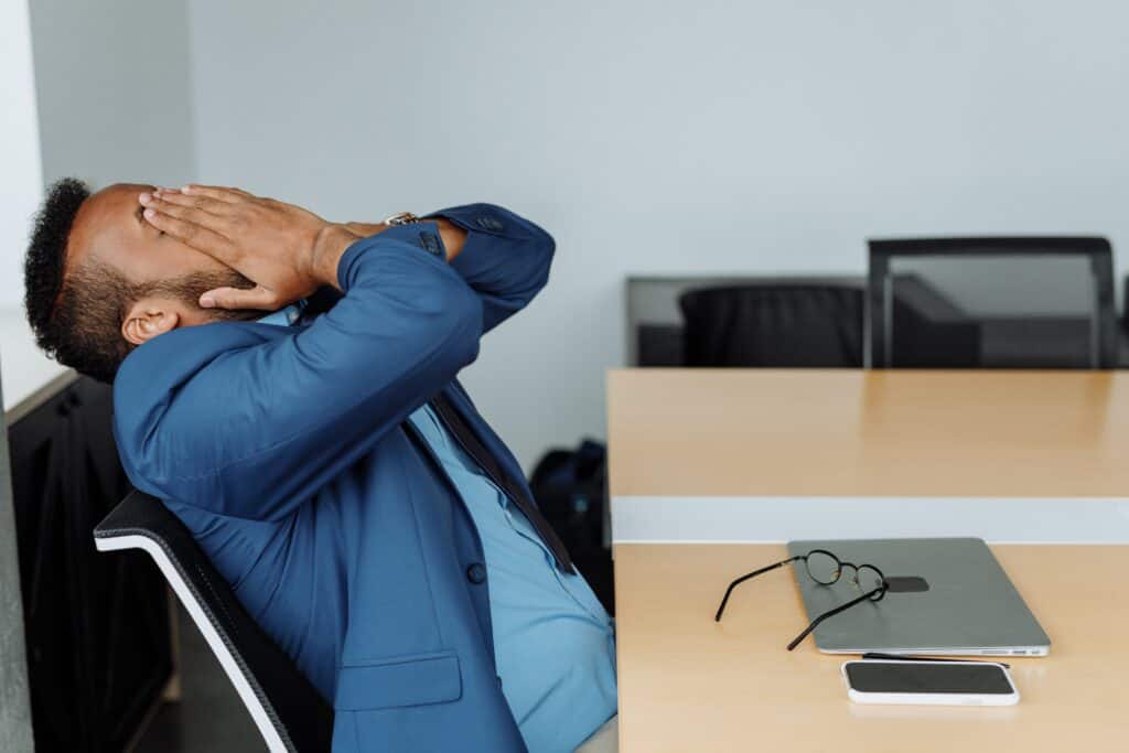 Stressed owner-manager overwhelmed by business challenges and paperwork