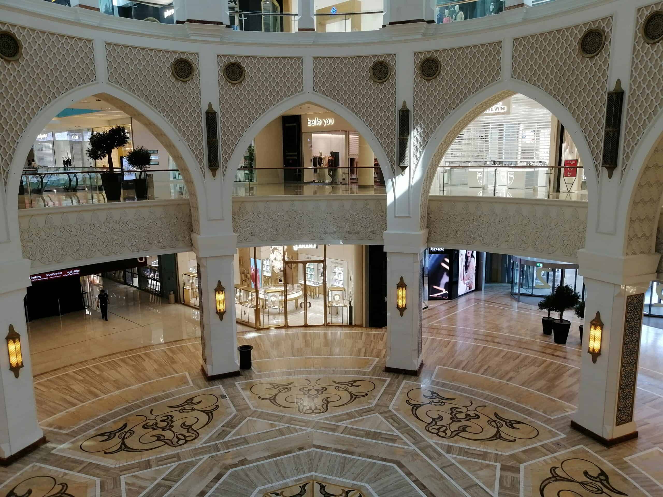 Luxurious interior view of Dubai Mall featuring stunning Arabic arches and intricate flooring design.