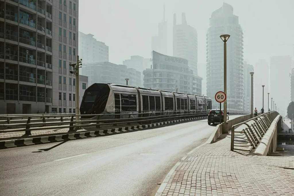 Modern tram travelling through Dubai’s urban skyline, representing UAE Etihad Rail and public transport innovation.