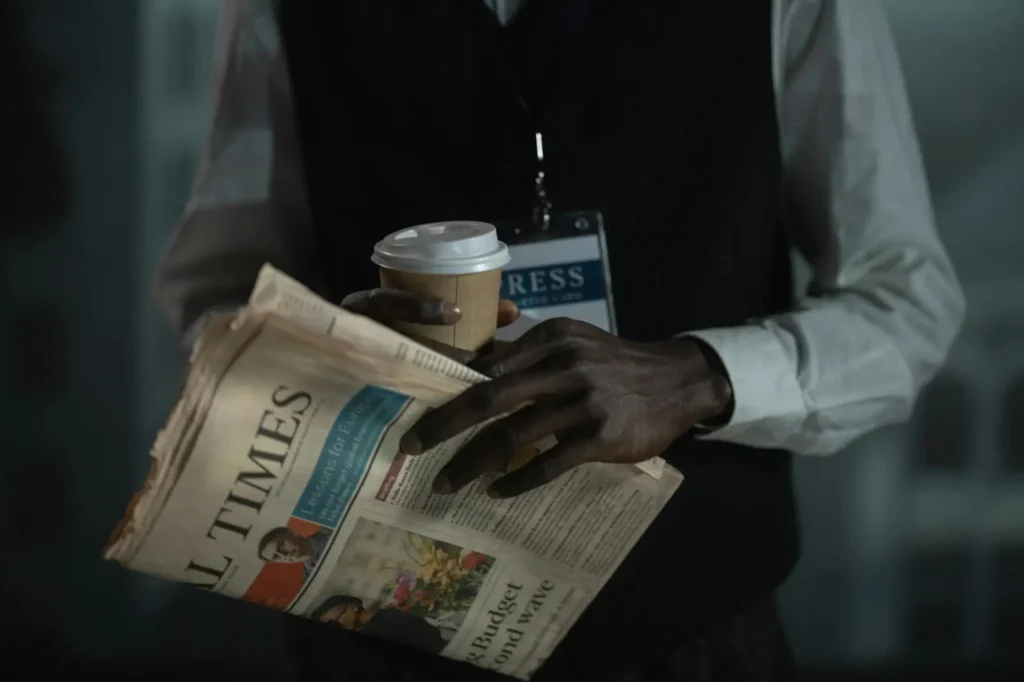 UAE News Roundup 30 May 2025: close-up of a journalist holding a newspaper and coffee cup, symbolising professional news reporting and media.