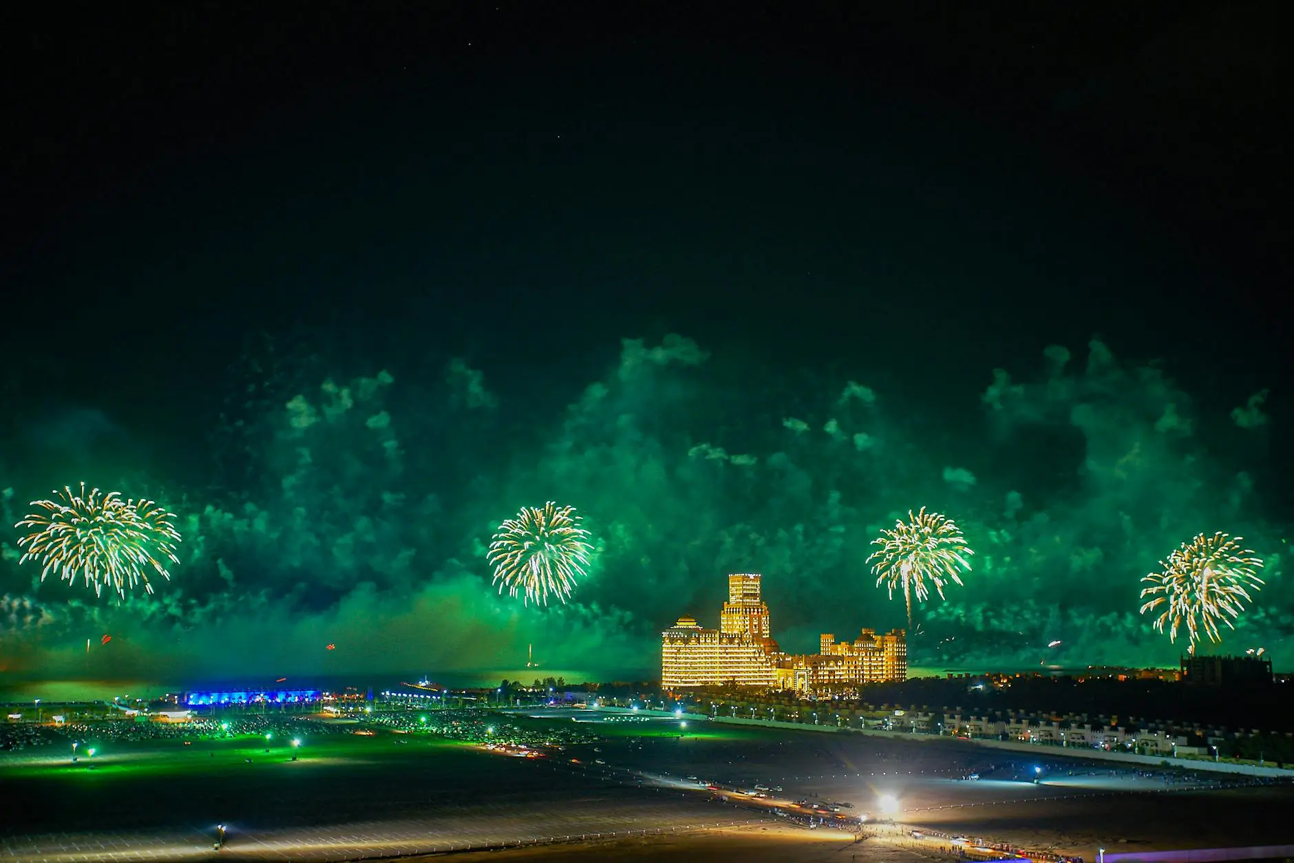 Eid al-Adha fireworks light up the night sky over Ras Al Khaimah, UAE, with city buildings and crowds watching the celebration in 2025.