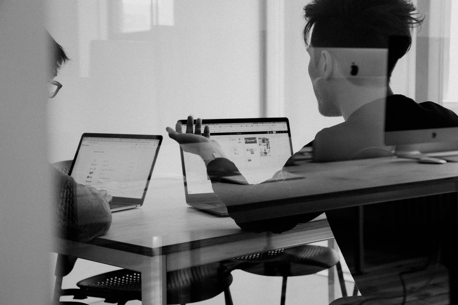 Modern office meeting with laptops, charts, and a logistics scene