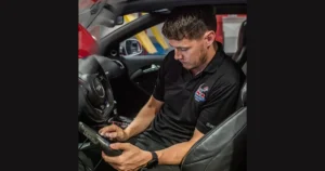 Glenn Power, lead technician and founder of Powerworks Garage Dubai, inspecting a car engine in the workshop