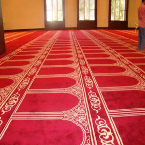 carpet inside a mosque with repeating patterns of stars and circles.jpg